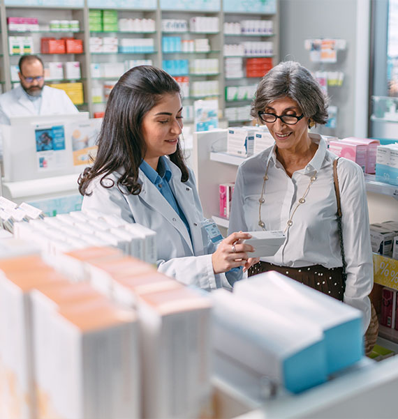 Pharmacist talking to customer in pharmacy